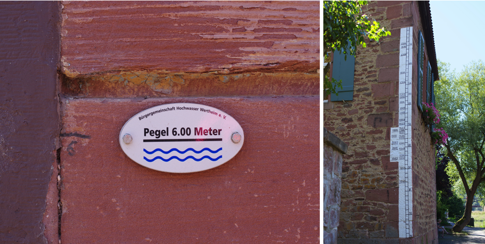 Pegelmarke und Hochwassermarken an Hausfassaden.